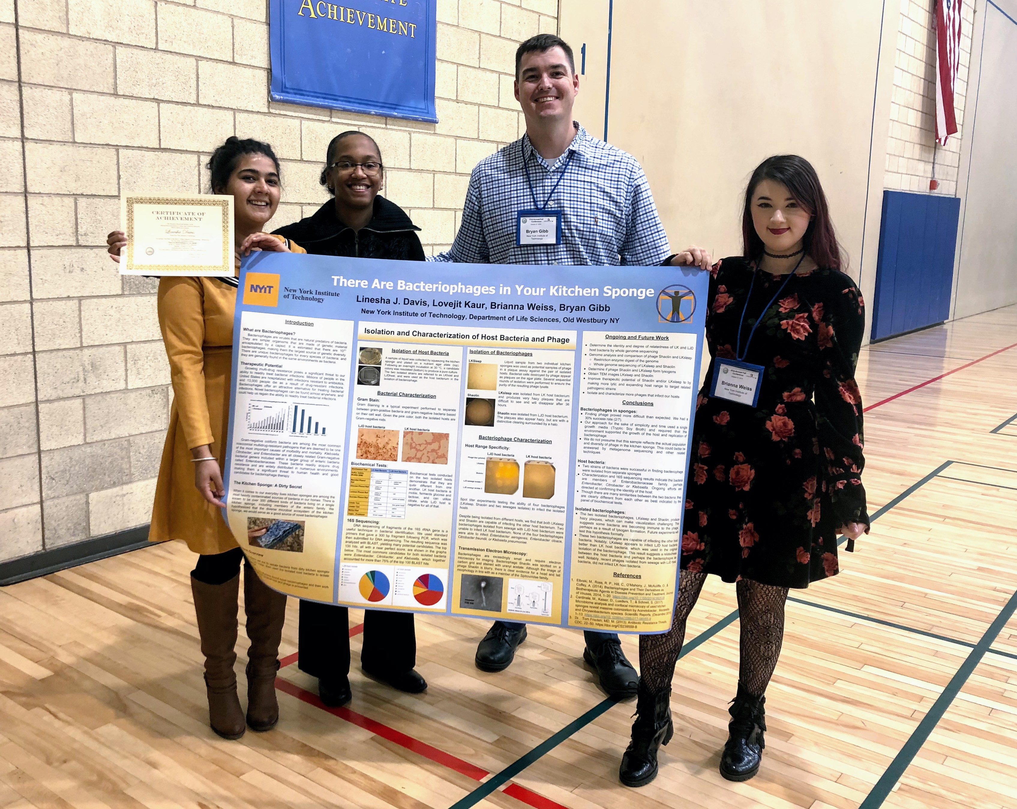 Life Science students, Lovejit Kaur, Linesha Davis and Brianna Weiss with mentor Bryan Gibb, which took first place for their work on bacteriophages in kitchen sponges.