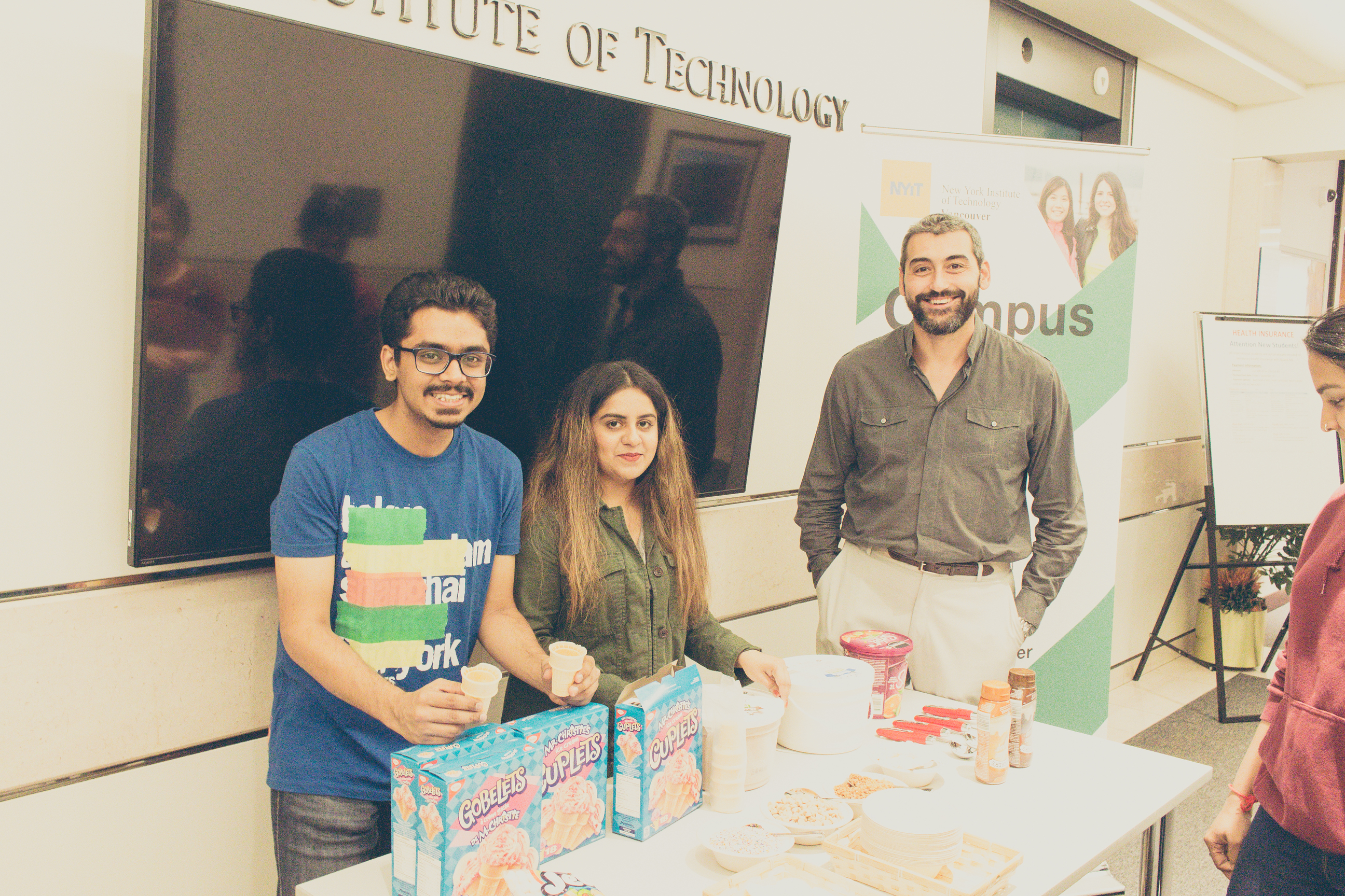 Volunteers and Dr. Sinan Caykoylu, Assistant Dean and Assistant Professor of the MBA program, giving away ice cream