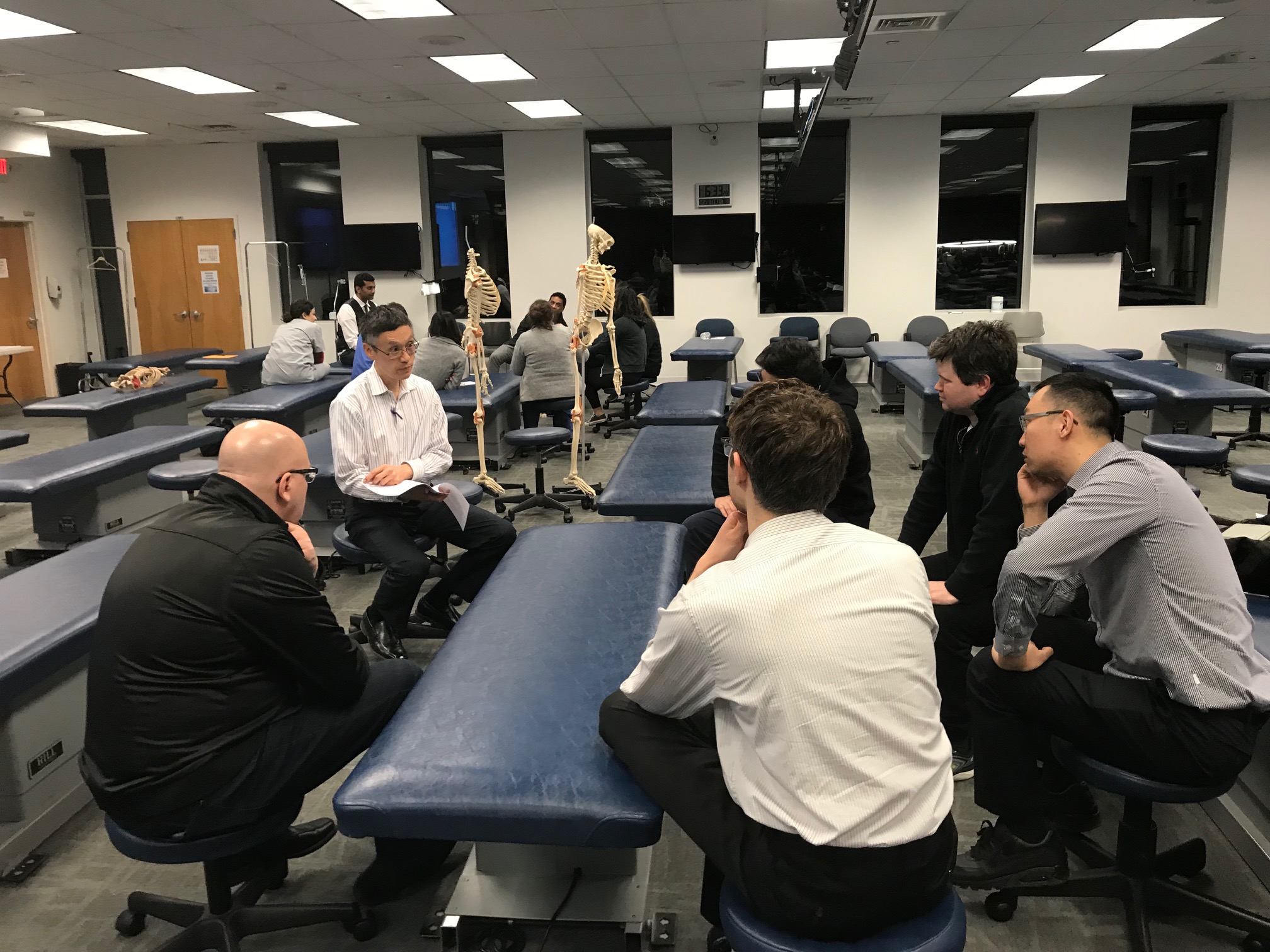 Dr. To Shan Li D.O. and the physician participants reviewing case scenarios with osteopathic considerations 