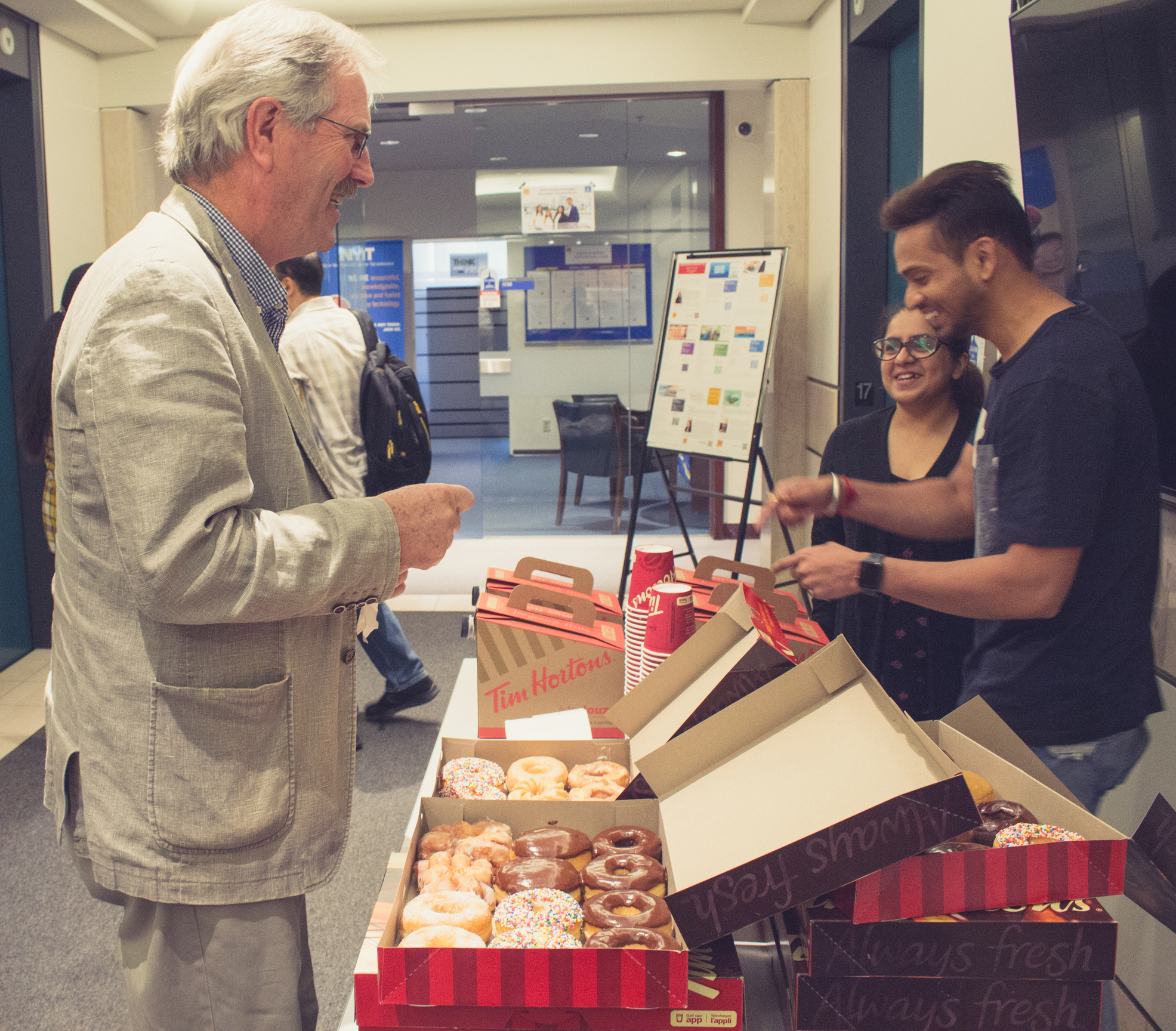 Frederick MacDonald, Assistant Dean for College of Engineering and Computing Science, enjoying the free coffee and donuts