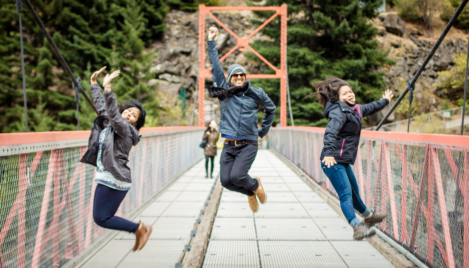 Students jump for joy on a bridge suspended over the Fraser River.
