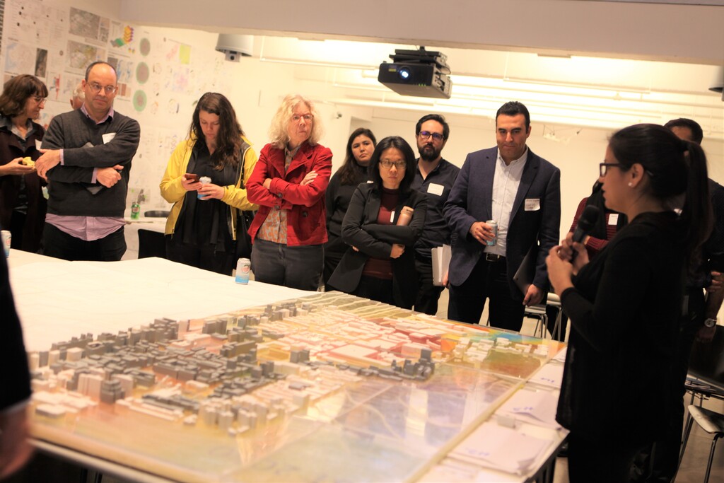 Urban design student presenting to leading experts on net-zero carbon district.