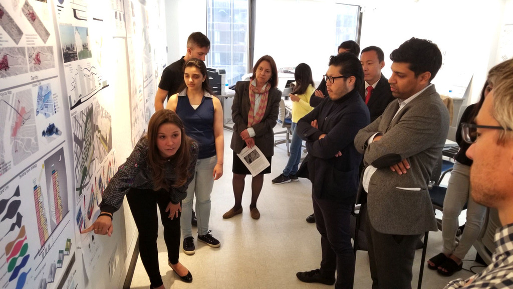 Graduate Student Luciana B. Nogueira Godinho pointing out work for jury